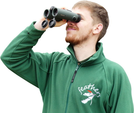 Young man birdwatching with Swarovski binoculars